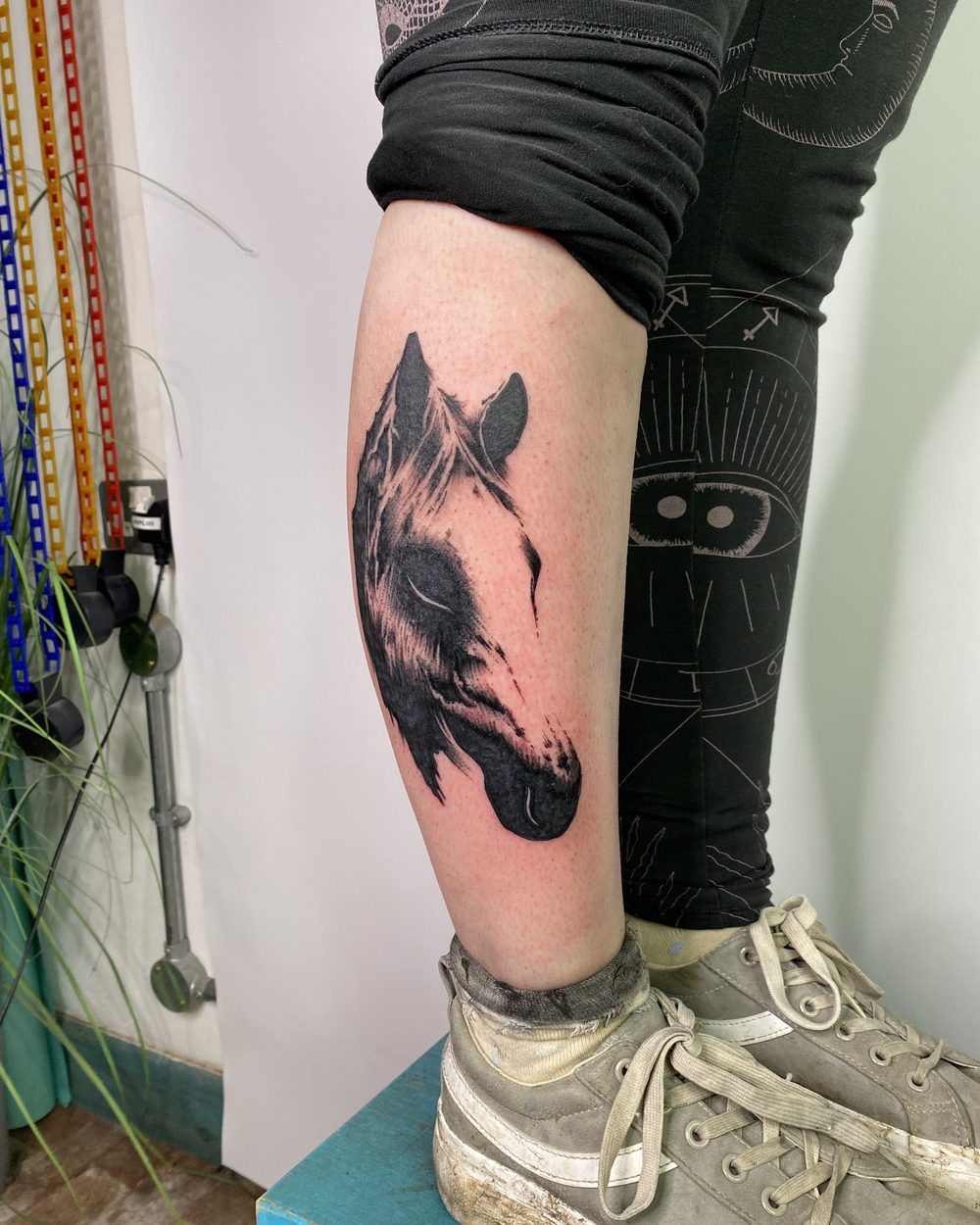 Coiled serpent wrapping a shoulder in illustrative blackwork